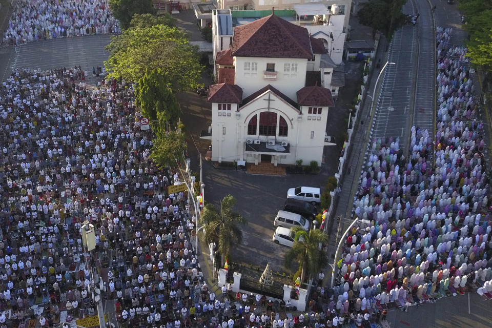 In this photo taken using a drone, Muslims perform Eid al-Adha prayers on the street in Jakarta, Indonesia, Sunday, July 10, 2022. Muslims around the world celebrated Eid al-Adha, or Festival of Sacrifice, slaughtering sheep, goats, cows and camels to commemorate Prophet Abraham's readiness to sacrifice his son Ismail on God's command. (AP Photo/Achmad Ibrahim)