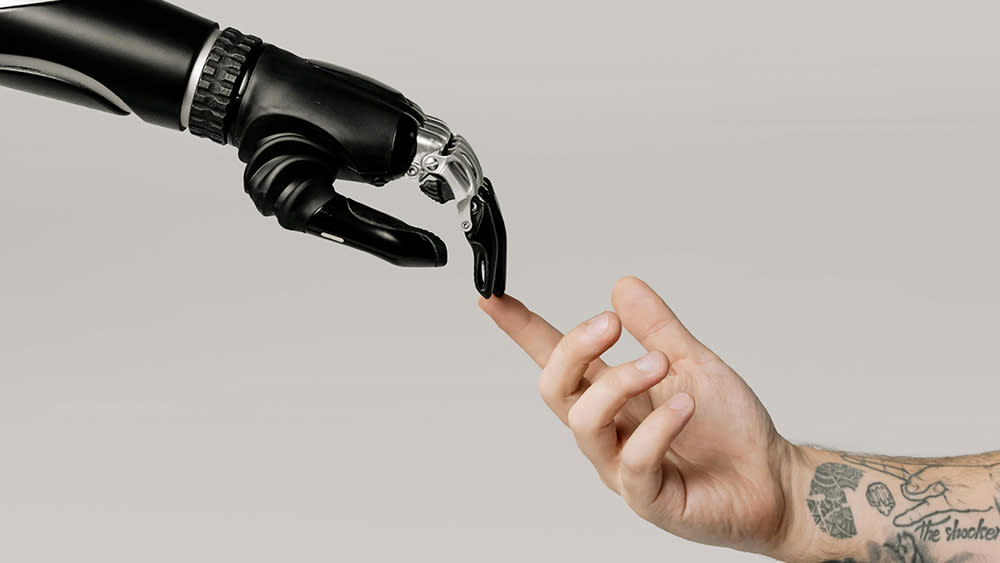  An image of a human hand touching an AI-powered robot hand. 