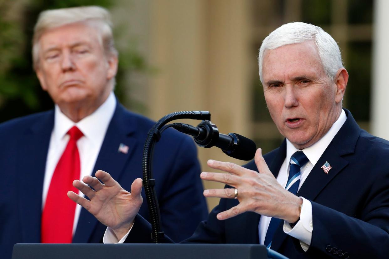 Former Vice President Mike Pence, right, speaks as former President Donald Trump looks on.