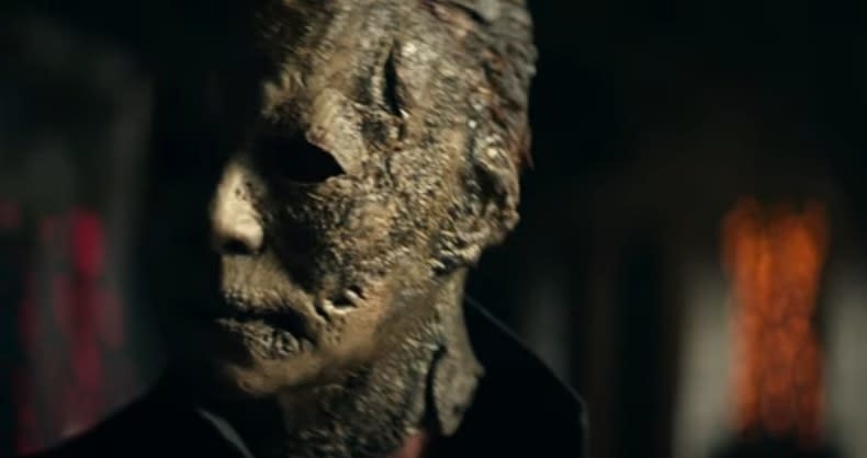 Michael Myers looks around in a burned mask