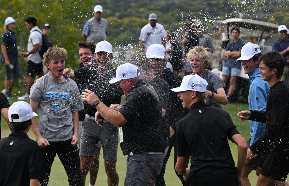 Corner Canyon’s Head Golf coach Derek Fox gets hit with water from his team as they celebrate their win in 6A Golf at Old Mill Golf Course in Holladay on Tuesday, Oct. 10, 2023. | Scott G Winterton, Deseret News