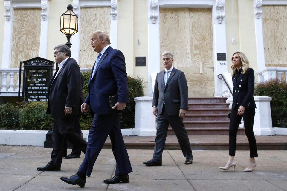 President Donald Trump departs after visiting outside St. John's Church across Lafayette Park from the White House Monday, June 1, 2020, in Washington. Part of the church was set on fire during protests on Sunday night. Walking with Trump are Attorney General William Barr, from left, White House national security adviser Robert O'Brien and White House press secretary Kayleigh McEnany. (AP Photo/Patrick Semansky)