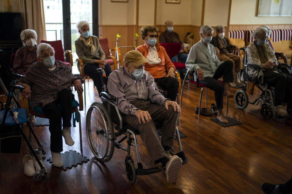 Residents take part in a gym session at the Icaria nursing home in Barcelona, Spain, Monday, Nov. 11, 2020. Virus cases among the elderly are again on the rise across Europe, causing havoc and rising death tolls in nursing homes despite the lessons of a tragic spring. Authorities are in a race to save lives as they wait for crucial announcements on mass vaccinations. (AP Photo/Emilio Morenatti)