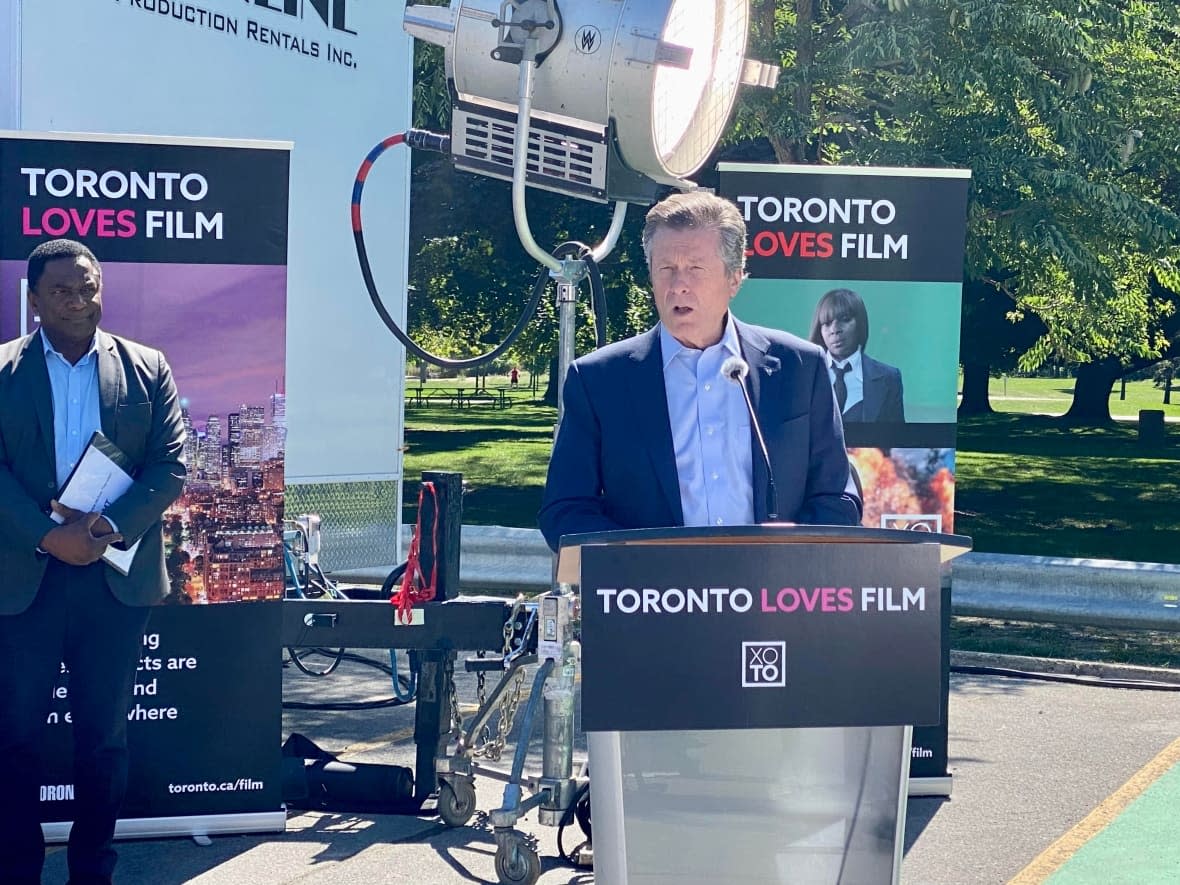 Toronto Mayor John Tory announces a new program to give film and television production crews access to power drops in two city parks. The move will make it easier for the crews to access clean electricity off the grid rather than burn diesel fuel to power their cast and production trailers.  (Martin Trainor/CBC - image credit)
