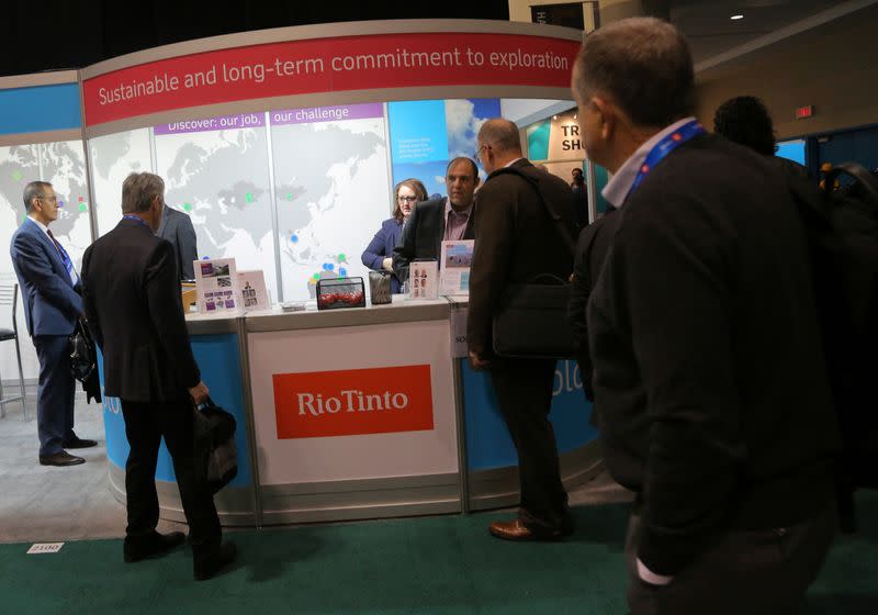 FILE PHOTO: Visitors to the Rio Tinto mining company booth speak with representatives during the PDAC convention in Toronto