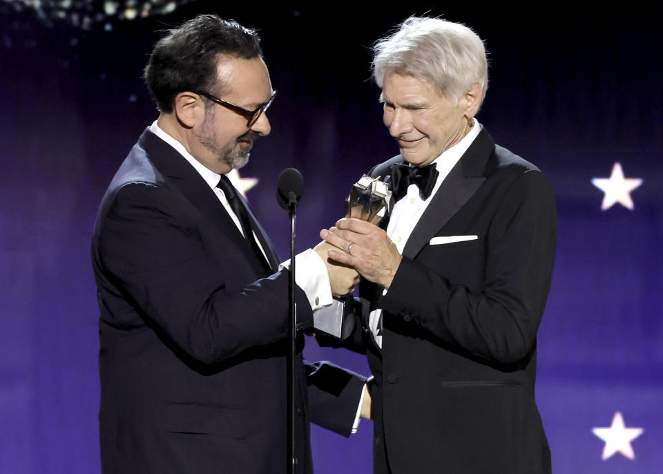 SANTA MONICA, CALIFORNIA - JANUARY 14: (L-R) James Mangold presents Harrison Ford with the Career Achievement Award during the 29th Annual Critics Choice Awards at Barker Hangar on January 14, 2024 in Santa Monica, California. (Photo by Kevin Winter/Getty Images for Critics Choice Association)