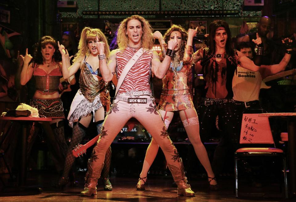 This undated publicity photo released by the Vivacity Media Group shows Joey Calveri, center, as “Stacee Jaxx” in a scene from “Rock of Ages," in New York. The cast of the Broadway show will be part of the televised pregame entertainment before Sunday’s Super Bowl on Feb. 2, 2014. (AP Photo/Vivacity Media Group, Paul Kolnik)