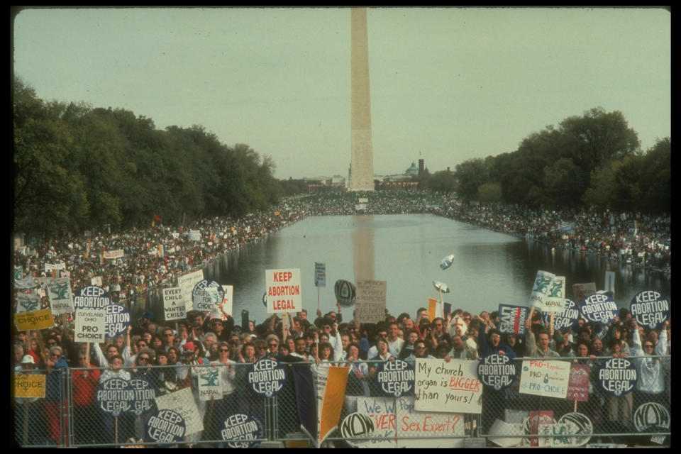 Protesters crowd the space around the Washington Monument and reflecting pool