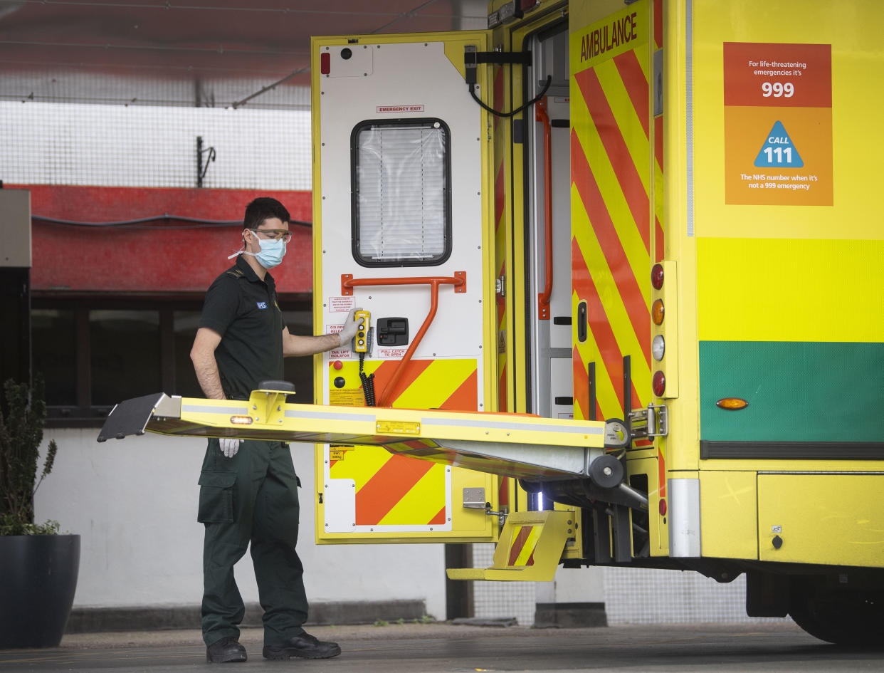 A paramedic escorts a patient arriving at St Thomas' Hospital in Westminster, London as the UK continues in lockdown to help curb the spread of the coronavirus.