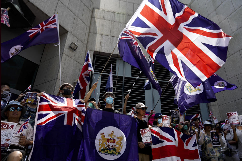 Protesters wave British flags during a peaceful demonstration outside the British Consulate in Hong Kong, Sunday, Sept. 15, 2019. Hundreds of Hong Kong activists rallied outside the Consulate for a second time this month, bolstering calls for international support in their months-long protests for democratic reforms in the semi-autonomous Chinese territory. (AP Photo/Vincent Yu)