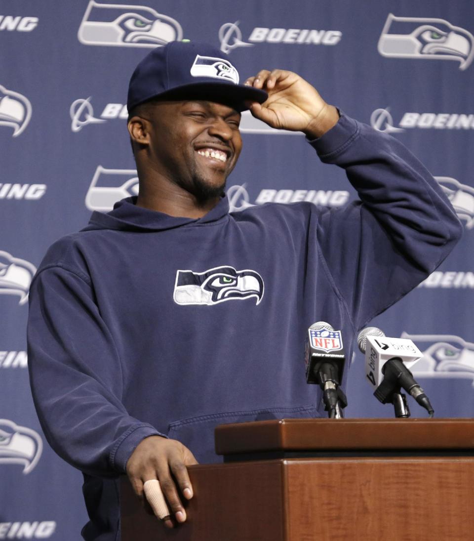 Seattle Seahawks defensive end Cliff Avril laughs as he begins an NFL football news conference Monday, Jan. 13, 2014, in Renton, Wash. The Seahawks play the San Francisco 49ers Sunday in the NFC championship game. (AP Photo/Elaine Thompson)