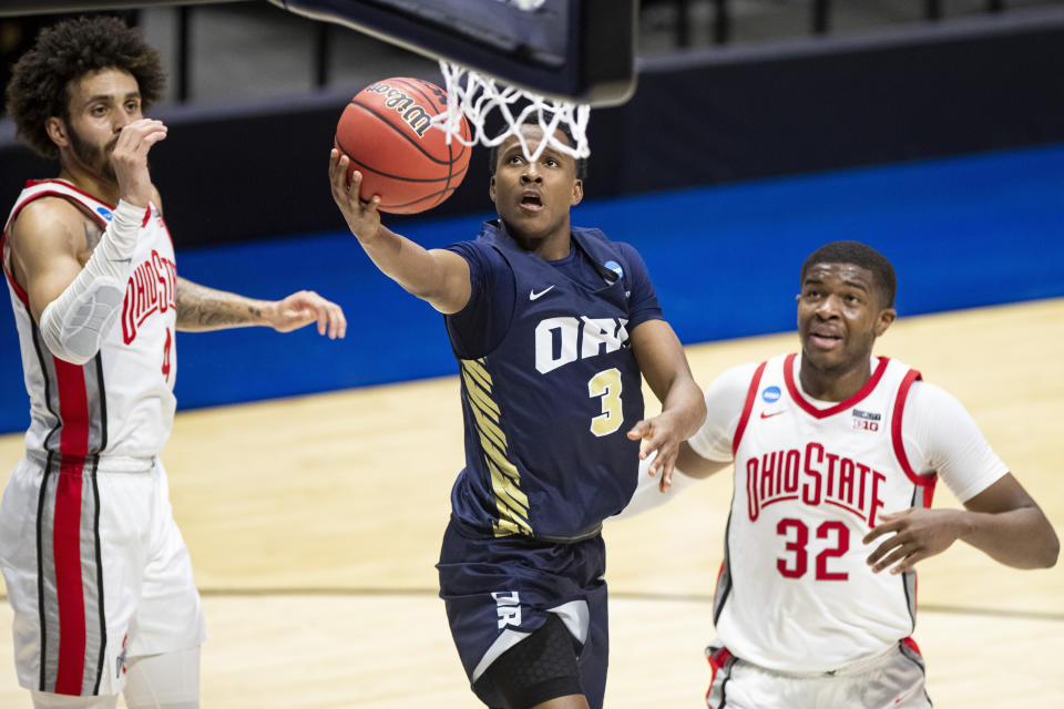 FILE - Roberts' Max Abmas (3) lays up between Ohio State's Duane Washington Jr. (4) and E.J. Liddell (32) during the second half of a first round game in the NCAA men's college basketball tournament on March 19, 2021, at Mackey Arena in West Lafayette, Ind. Abmas burst onto the scene in 2021 when he averaged 26.7 points in three NCAA Tournament games to help Oral Roberts beat Ohio State and Florida before falling to Arkansas in the Sweet 16. (AP Photo/Robert Franklin, File)