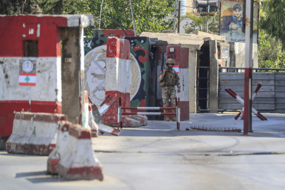 A Lebanese soldier takes position during clashes that erupted between members of the Palestinian Fateh group and Islamist militants in the Palestinian refugee camp of Ein el-Hilweh near the southern port city of Sidon, Lebanon, Sunday, July 30, 2023. Palestinian officials say at least five people have been killed and several others wounded during clashes in Lebanon’s largest Palestinian refugee camp. (AP Photo/Mohammad Zaatari)