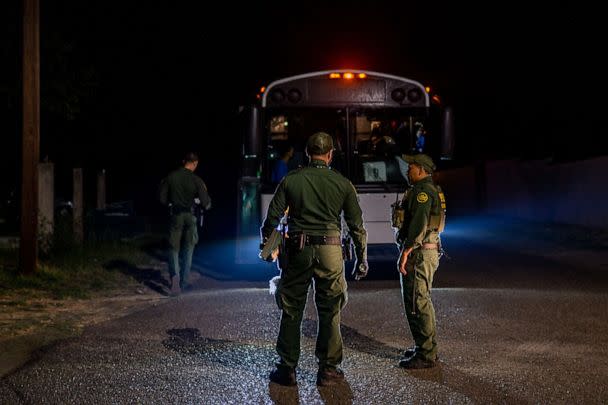 PHOTO: Border Patrol officers speak together after processing and loading migrants onto a bus, May 5, 2022, in Roma, Texas. (Brandon Bell/Getty Images, FILE)