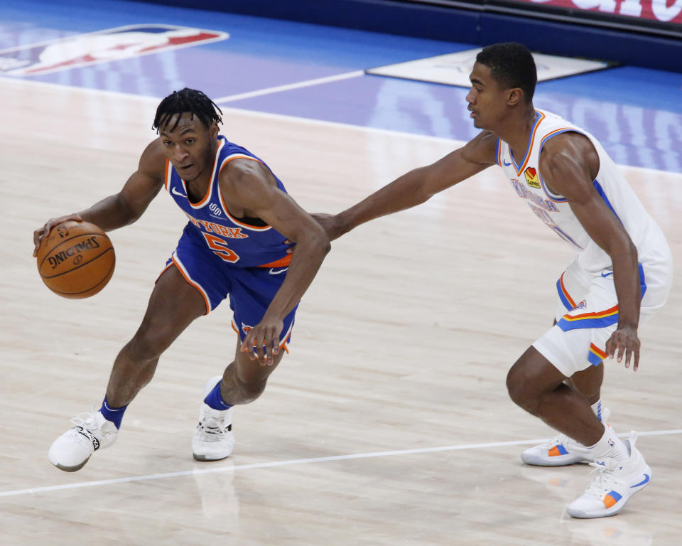 New York Knicks guard Immanuel Quickley (5) drives the ball against Oklahoma City Thunder guard Theo Maledon (11) during the second half of an NBA basketball game, Saturday, March 13, 2021, in Oklahoma City. (AP Photo/Garett Fisbeck)