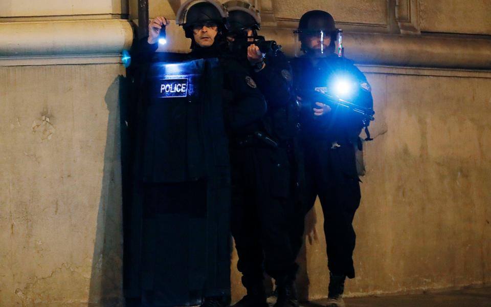 Police officers block the access of a street near the Champs Elysees in Paris - Credit: AFP