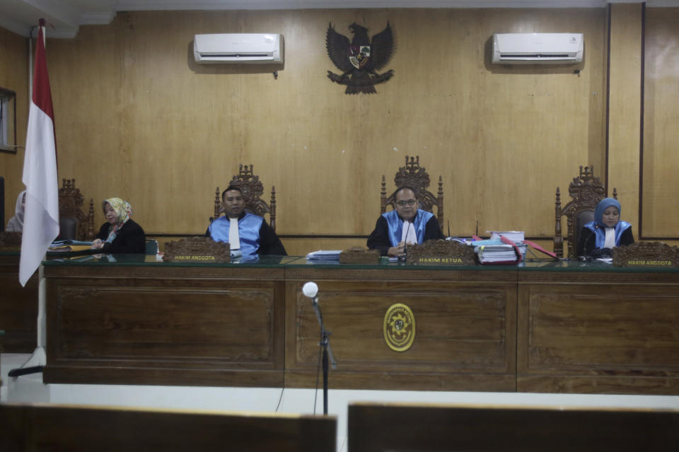 Presiding judge Jimmy C. Paraded, center, announces the decision of a three-judge on environmental activists' legal challenge against the construction of a Chinese-backed dam that they claimed will rip through the habitat of the most critically endangered orangutan species, at the administrative court in Medan, North Sumatra, Indonesia, Monday, March 4, 2019. The court ruled that the construction can continue despite critics of the 510-megawatt hydro dam providing evidence that its environmental impact assessment was deeply flawed. (AP Photo/Binsar Bakkara)