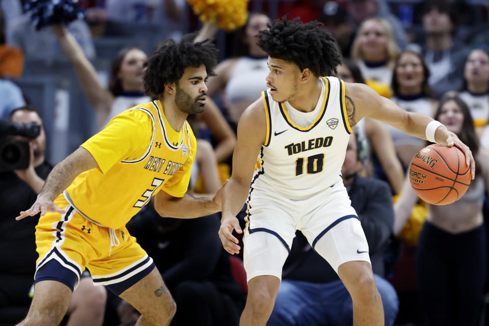 Toledo guard RayJ Dennis (10) plays against Kent State guard Sincere Carry (3) during the first half of an NCAA college basketball game for the championship of the Mid-American Conference Tournament, Saturday, March 11, 2023, in Cleveland. (AP Photo/Ron Schwane)
