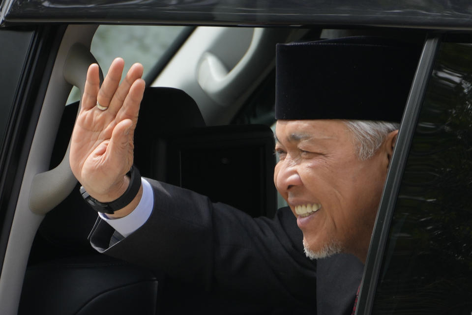 United Malays National Organization President Ahmad Zahid Hamidi waves as he leaves after meeting with King Sultan Abdullah Sultan Ahmad Shah at National Palace in Kuala Lumpur, Malaysia, Wednesday, Nov. 23, 2022. (AP Photo/Vincent Thian)