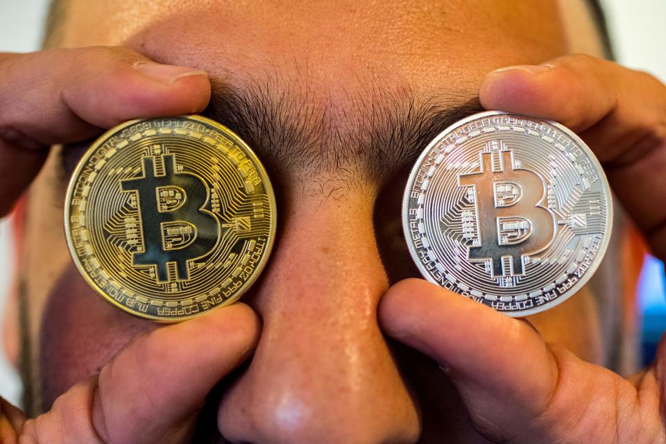 Moving fast: A person holds up a visual representation of bitcoin at the 'Bitcoin Change' store in the Israeli city of Tel Aviv.  Photo: JACK GUEZ/AFP/Getty Images.