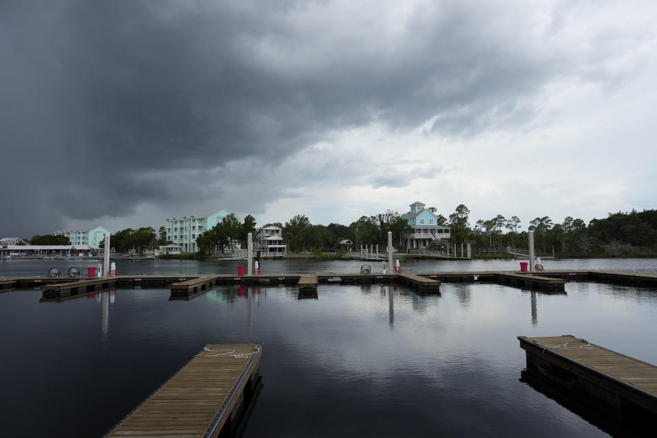 Storm clouds loom over riverfront homes in Steinhatchee, Fla., ahead of the expected arrival of Hurricane Idalia, Tuesday, Aug. 29, 2023. Feeding on some of the hottest water on the planet, Hurricane Idalia is expected to rapidly strengthen as it bears down on Florida and the rest of the Gulf Coast, scientists said. (AP Photo/Rebecca Blackwell)