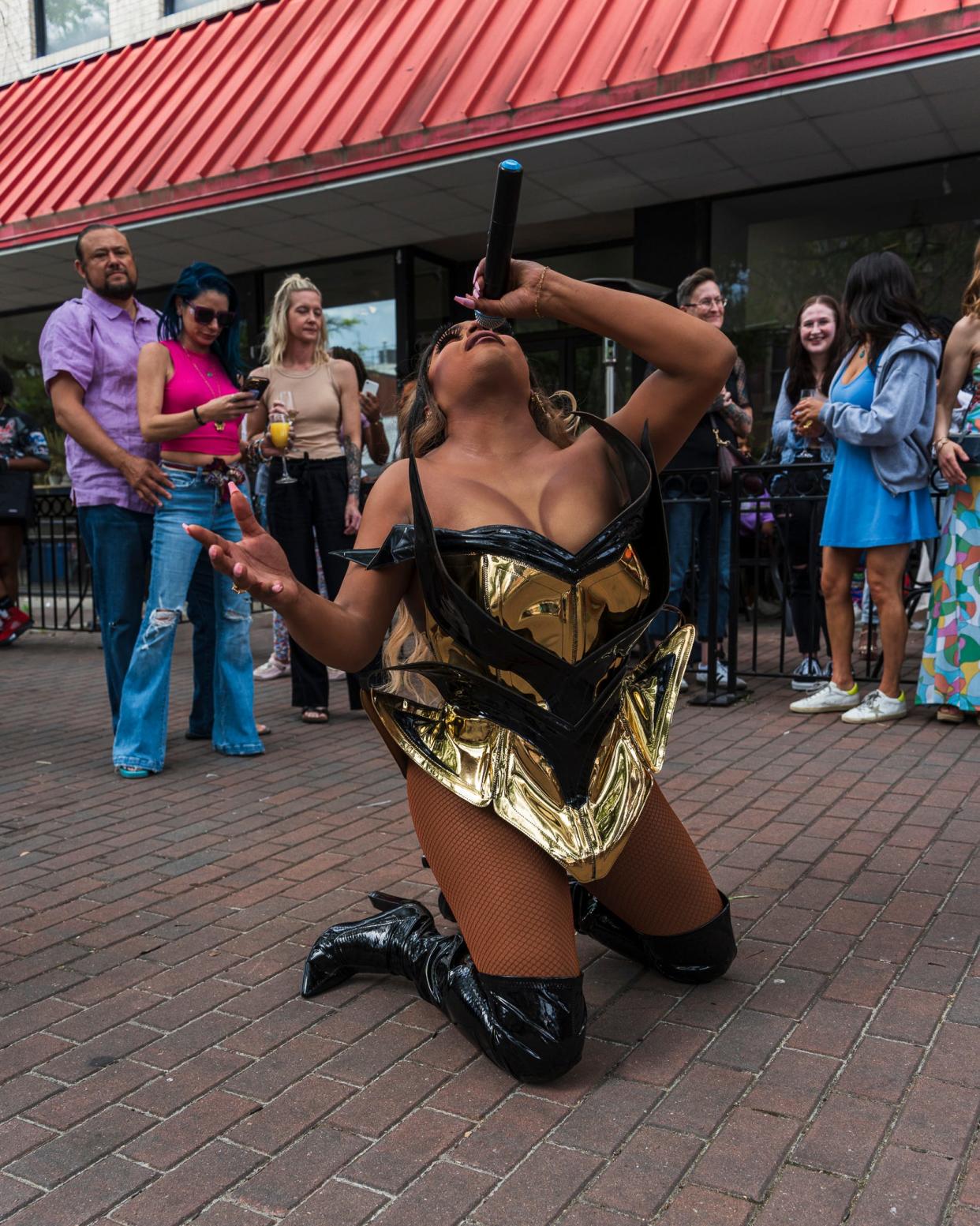 Durham-based drag queen Naomi Dix performs outside of The Sip Room on Hay Street in Fayetteville during the Dogwood Festival, April 27, 2024.