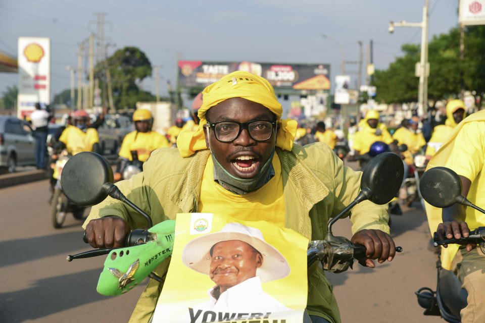 A supporter of Ugandan President Yoweri Kaguta Museveni celebrates in Kampala, Uganda, Saturday Jan. 16, 2021, after their candidate was declared winner of the presidential elections. Uganda’s electoral commission says longtime President Yoweri Museveni has won a sixth term, while top opposition challenger Bobi Wine alleges rigging and officials struggle to explain how polling results were compiled amid an internet blackout. In a generational clash widely watched across the African continent, the young singer-turned-lawmaker Wine posed arguably the greatest challenge yet to Museveni. (AP Photo/Nicholas Bamulanzeki)