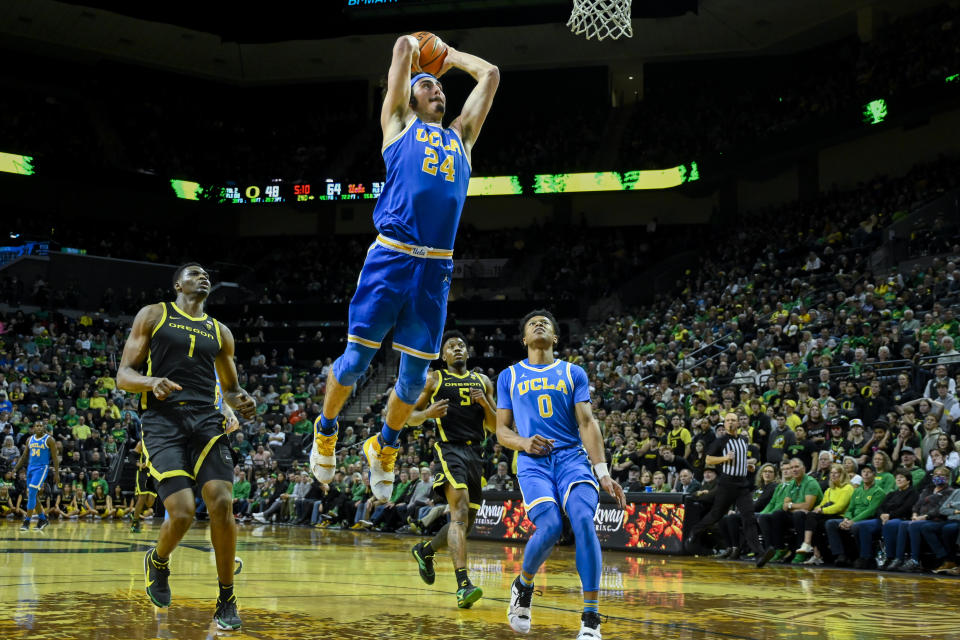 FILE - UCLA guard Jaime Jaquez Jr. (24) dunks over Oregon center N'Faly Dante (1) as Oregon guard Jermaine Couisnard (5) and UCLA guard Jaylen Clark (0) trail on the play during the second half of an NCAA college basketball game Saturday, Feb. 11, 2023, in Eugene, Ore. Jaquez was named The Associated Press player of the year in the Pac-12 Conference on Tuesday, March 7, 2023. (AP Photo/Andy Nelson, File)