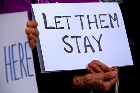 Refugee advocates hold signs as they protest against the detention of asylum seekers being held at Australian-run offshore detention centers located on Papua New Guinea's Manus Island, and the South-Pacific island of Nauru, in central Sydney, Australia, August 31, 2017. REUTERS/David Gray