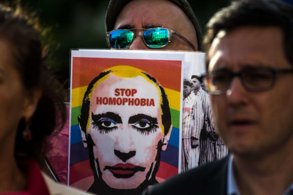 A man showing a picture of Vladimir Putting during a protest supporting LGBTQ+ people in 2017. / Credit: Marcos del Mazo/LightRocket via Getty Images