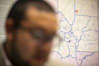 Ricky Hurtado, a Democratic candidate for the North Carolina state house, strategizes inside his campaign headquarters, in Graham, N.C., Tuesday, March 10, 2020, in front of a map of Alamance County. He is the first Latino candidate to run for North Carolina's House of Representatives. (AP Photo/Jacquelyn Martin)