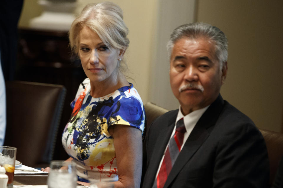 White House counselor Kellyanne Conway, left, and Hawaii Gov. David Ige listen as President Donald Trump speaks during a meeting with governors on "workforce freedom and mobility" in the Cabinet Room of the White House, Thursday, June 13, 2019, in Washington. (AP Photo/Evan Vucci)