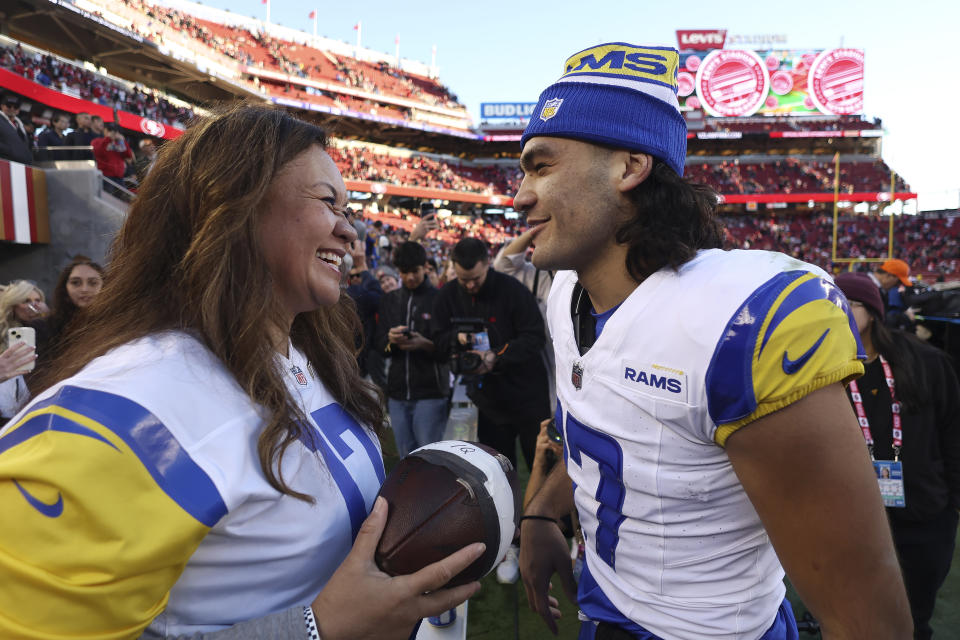 Los Angeles Rams wide receiver Puka Nacua, right, talks with his mother, Penina Nacua, after the Rams defeated the San Francisco 49ers in an NFL football game in Santa Clara, Calif., Sunday, Jan. 7, 2024. (AP Photo/Jed Jacobsohn)