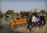 A Nihang or a Sikh warrior on a horse arrives at Singhu, Delhi-Haryana border for ongoing farmers protest against three farm bills, in New Delhi, India, Wednesday, Jan. 27, 2021. Tens of thousands of farmers who stormed the historic Red Fort on India’s Republic Day are again camped outside the capital after the most volatile day of their two-month standoff left one protester dead and more than 300 police officers injured. (AP Photo/Manish Swarup)