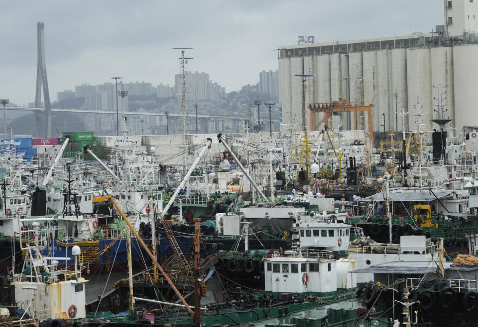 Ships are anchored in a port as the tropical storm named Khanun approaches to the Korean Peninsular, in Busan, South Korea, Wednesday, Aug. 9, 2023. Dozens of flights and ferry services were grounded in South Korea on Wednesday ahead of the tropical storm that has dumped heavy rain on Japan's southwestern islands for more than a week. (AP Photo/Ahn Young-joon)