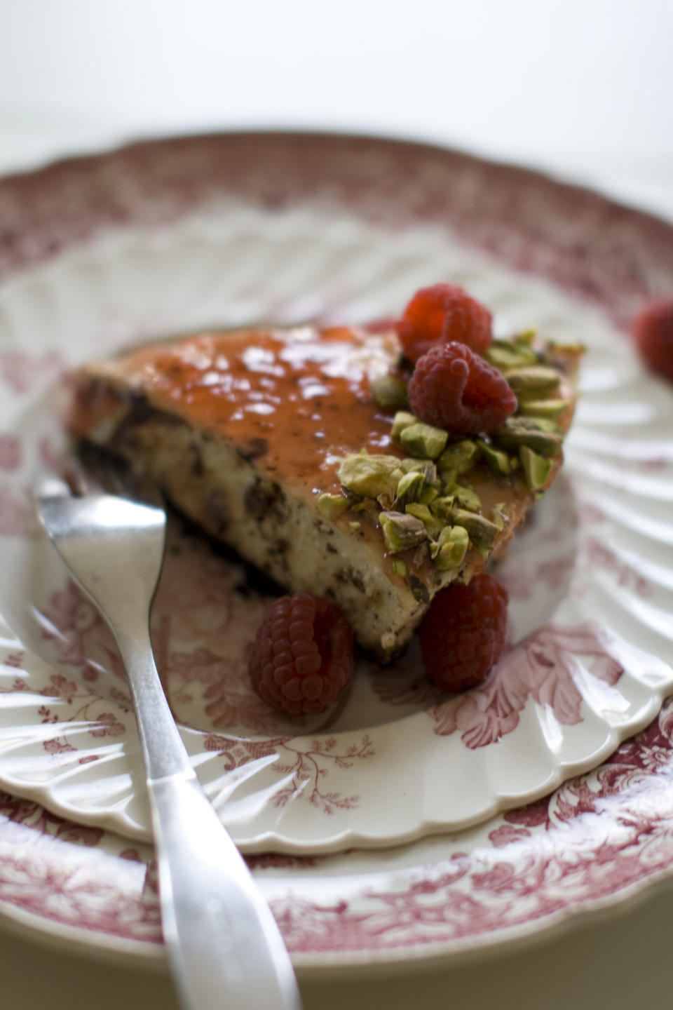 This Nov. 11, 2013 photo shows red currant and chocolate cheesecake in Concord, N.H. In this recipe, chopped chocolate is a distinct, toothsome confetti strewn throughout the cake. (AP Photo/Matthew Mead)