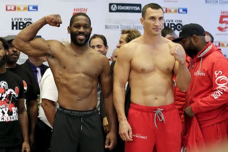 Reigning heavyweight champion Wladimir Klitschko of Ukraine and U.S. boxer Bryant Jennings clench their fists during an official weigh-in ahead of their fight in New York April 24, 2015. REUTERS/Eduardo Munoz