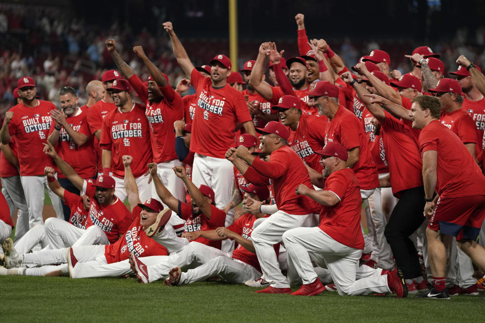 Members of the St. Louis Cardinals celebrate after defeating the Milwaukee Brewers in a baseball game to clinch a playoff spot Tuesday, Sept. 28, 2021, in St. Louis. (AP Photo/Jeff Roberson)