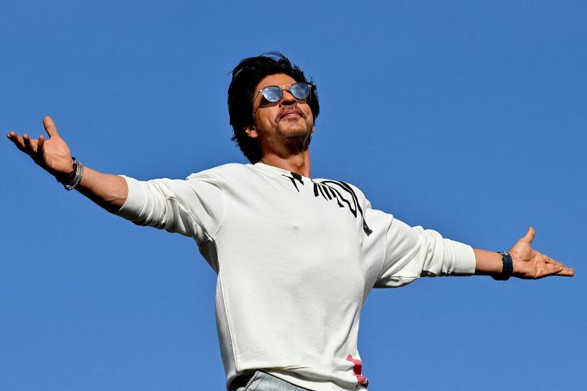 TOPSHOT - Bollywood actor Shah Rukh Khan greets fans with his iconic pose at his residence Mannat in Mumbai on June 10, 2023. (Photo by Sujit JAISWAL / AFP) (Photo by SUJIT JAISWAL/AFP via Getty Images)