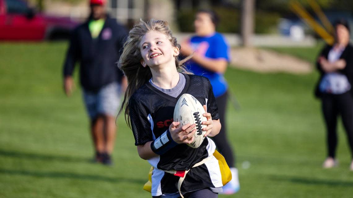 Lauren Ruhter, 11, runs from the defense at practice on April 17 at Settlers Park in Meridian. It is the inaugural season for girls flag football in the Treasure Valley. Sarah A. Miller/smiller@idahostatesman.com