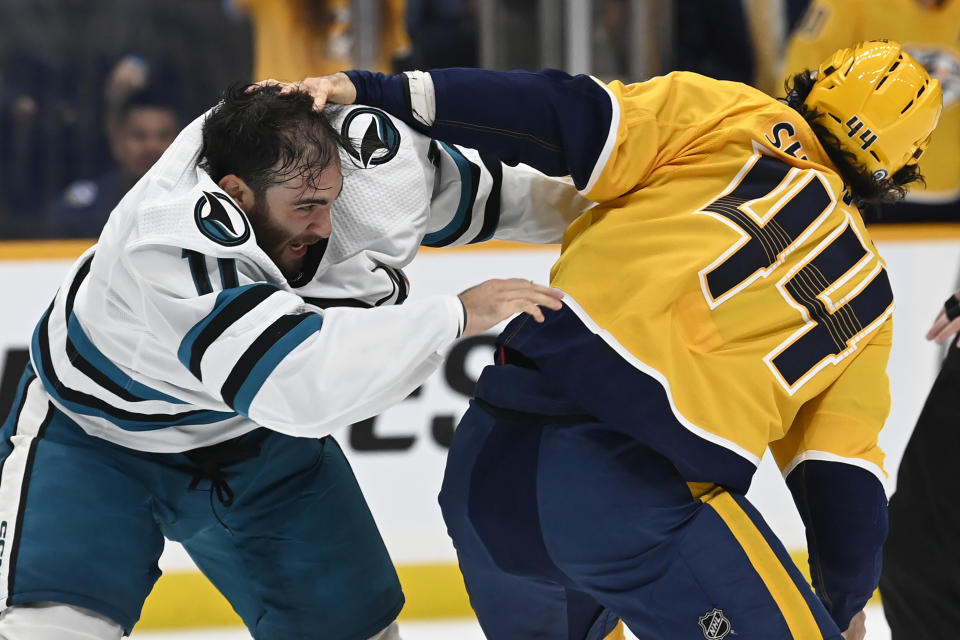 San Jose Sharks center Luke Kunin (11) fights with Nashville Predators left wing Kiefer Sherwood (44) during the second period of an NHL hockey game Saturday, Oct. 21, 2023, in Nashville, Tenn. (AP Photo/Mark Zaleski)