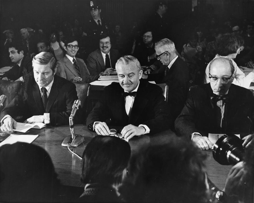 Supreme Court nominee John Paul Stevens is flanked by Sen. Charles Percy, left, and Attorney General Edward Levi at a confirmation hearing before the Senate Judiciary Committee in Washington, D.C., on Dec. 8, 1975. | Douglas Chevalier—The Washington Post/Getty Images