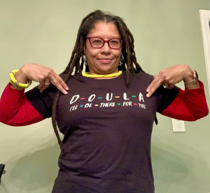 Death doula Raylene Driver Hill of Greensboro, North Carolina, wears one of her collection of appropriate T-shirts.
