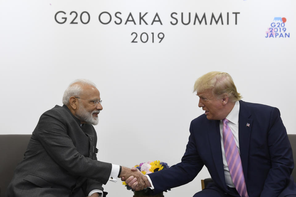 FILE- In this June 28, 2019 file photo, President Donald Trump shakes hands with Indian Prime Minister Narendra Modi, left, during a meeting on the sidelines of the G-20 summit in Osaka, Japan. India's opposition leaders are angrily demanding Modi clarify his position in Parliament about Trump mediating India's long-running dispute with Pakistan over Kashmir. India's External Affairs Minister S. Jaishankar said in Parliament on Tuesday that Modi made no such request to Trump as the U.S. president had claimed. (AP Photo/Susan Walsh, File)