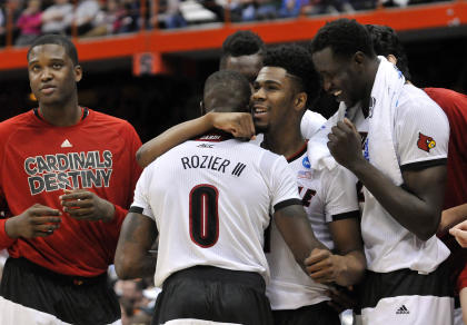 Anton Gill (1) hugs guard Terry Rozier (0) during the second half of Louisville's win over N.C. State. (USAT)