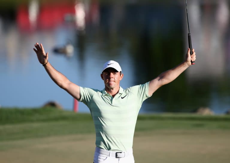 Rory McIlroy of Northern Ireland celebrates after making his birdie putt on the 18th green
