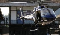 An helicopter takes up position during a crowd control training session, with FBI agents, for troops providing security for the 2014 World Cup, in Rio de Janeiro May 15, 2014. The World Cup will be held in 12 cities in Brazil from June 12 till July 13. REUTERS/Sergio Moraes (BRAZIL - Tags: CIVIL UNREST SPORT SOCCER WORLD CUP)