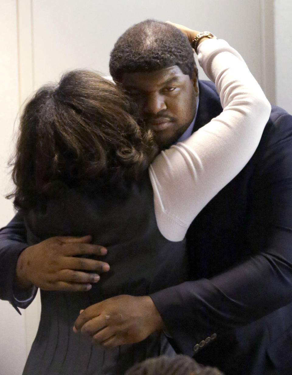 Former Dallas Cowboys NFL football player Josh Brent gets a hug from family after closing arguments in his intoxication manslaughter trial Tuesday, Jan. 21, 2014, in Waco, Texas. The jury has begun deliberating in Brent's intoxication manslaughter trial after lawyers wrapped up their closing arguments Tuesday morning. Prosecutors accuse the former defensive tackle of drunkenly crashing his Mercedes near Dallas during a night out in December 2012, killing his good friend and teammate, Jerry Brown. (AP Photo/LM Otero)