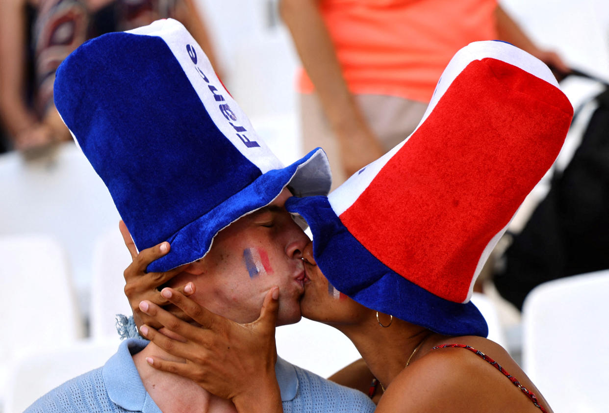 French fans kiss inside the stadium before the Men's Group A - New Zealand vs France football match in Marseille Stadium on July 30, 2024. (Luisa Gonzalez/Reuters)