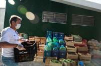 Former Brazil's head soccer coach Dunga helps with food distribution to poor people, amid the coronavirus disease (COVID-19) outbreak, in Porto Alegre